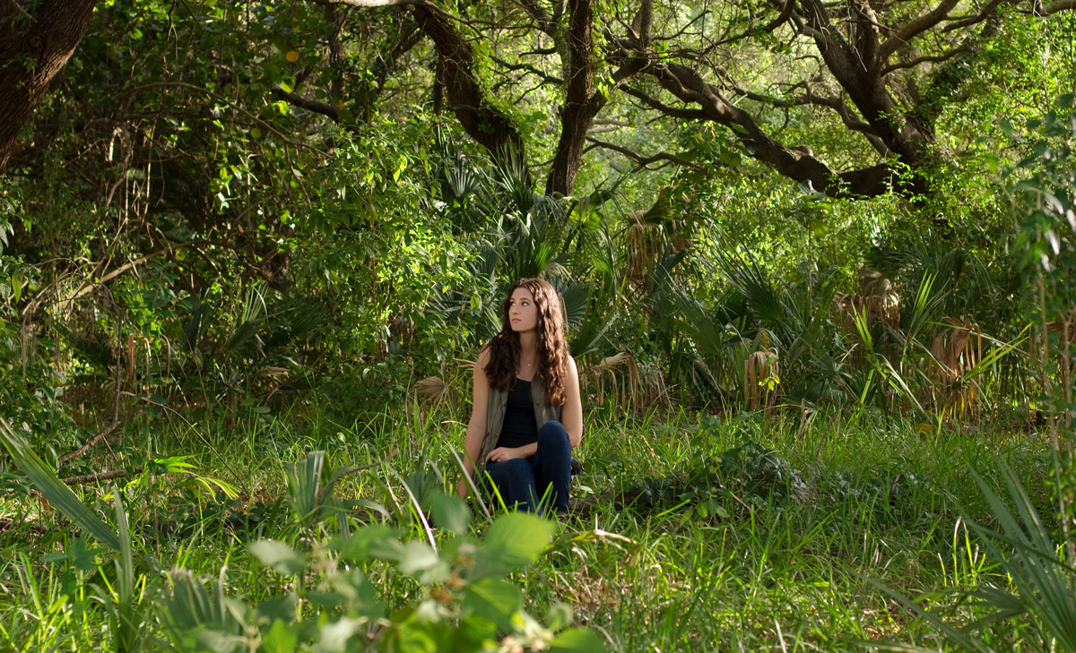 Kaylee Stepkoski sitting in the forrest