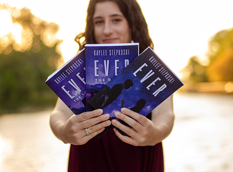 Kaylee Stepkoski holding her books in the EVER Series